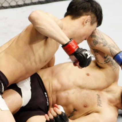 Choi Doo-ho pounds Sam Sicilia of the United States in a featherweight bout in Seoul. Photo: Getty Images
