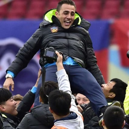 Tianjin Quanjian head coach Fabio Cannavaro celebrate with team supporters after the club won the China League One championship. Photos: Xinhua
