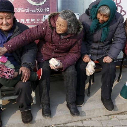An elderly couple feed their great-grandson as they sit in the winter sun in Jiaxing, Zhejiang province. By last year, China’s so called baby-boomers – those older than 65 – had grown to 144 million or 10.5 per cent of the population. Photo: Reuters