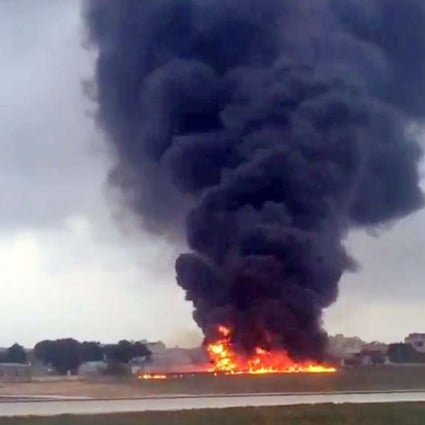 A passenger on another plane captured this image of the blazing wreckage of an unmarked plane at Malta International Airport ion Monday. Photo: EPA