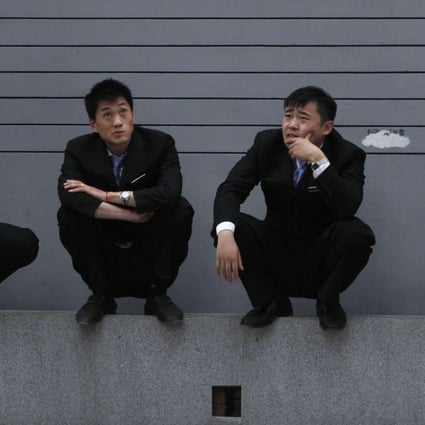 White collar workers take a break in Beijing. Photo: AP