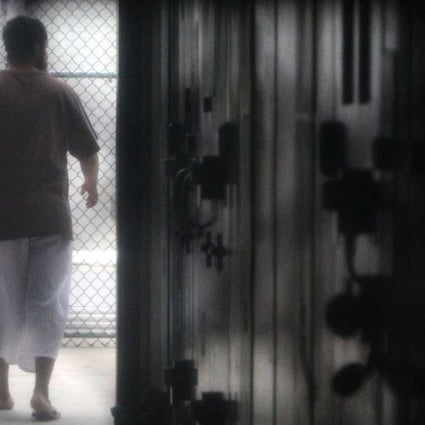 A prisoner walks around a communal cellblock in the US Navy base at Guantanamo Bay, Cuba. Photo: AFP