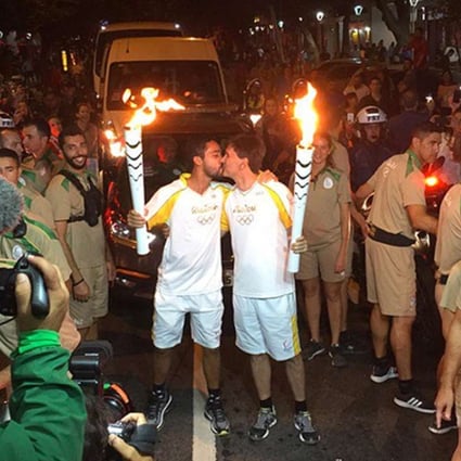 Two men celebrating the beginning of the Rio 2016 Olympic Games with a kiss. Photo: Twitter