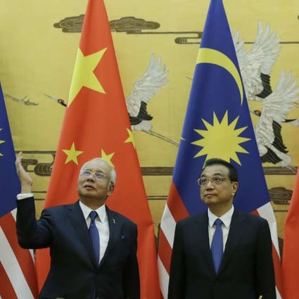 Malaysian Prime Minister Najib Razak and Premier Li Keqiang attend a signing ceremony at the Great Hall of the People in Beijing on Tuesday. Photo: AFP