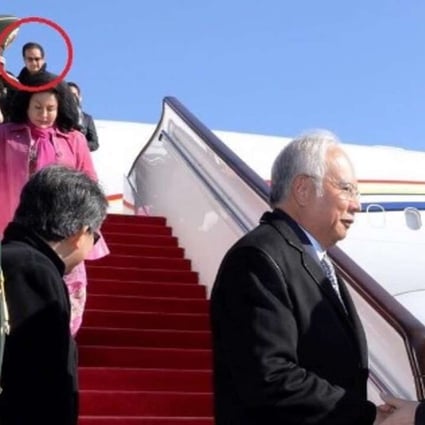 Najib Razak’s stepson Riza Aziz (circled red) exits the delegation’s official plane after it arrived in Beijing on Monday. Pictured below him are his mother Rosmah Mansor and Najib. Photo: Twitter
