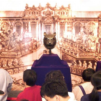 Three bronze heads, of a monkey, a tiger and an ox, are display at a private museum in Beijing in May 2000 after they were bought by a mainland company at an auction in Hong Kong. Considered national treasures from the old Summer Palace, the looted relics sparked an outcry from Chinese media, scholars and politicians when they were put up for sale. Photo: AFP