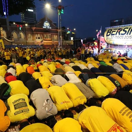Malaysian Muslims pray during the protest rally by electoral concern group Bersih last year. The release of the emails comes ahead of another rally planned by the group this month. Photo: AFP