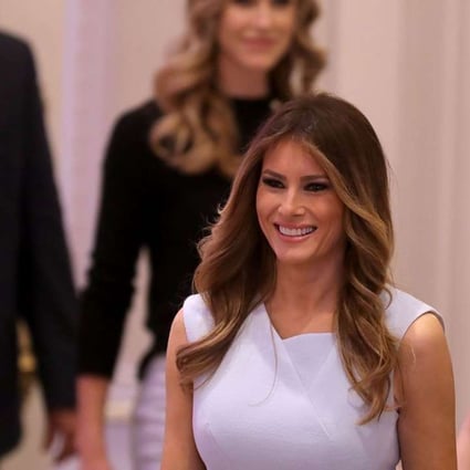 Melania Trump (C), wife of Republican presidential nominee Donald Trump, arrives for the grand opening ceremony at the new Trump International Hotel in Washington, DC. Photo: AFP