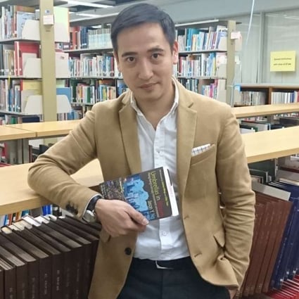 Jason Ng with a copy of his new book, Umbrellas in Bloom. Photo: Elaine Yau