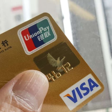 Dual-currency credit cards issued with both Visa and UnionPay logos will have to be replaced by cards carrying just the Chinese clearing company’s logo, under a central bank directive. Photo: Martin Chan