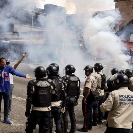 Riot police clash with protesters during a rally demanding a referendum to remove Venezuela's President Nicolas Maduro in San Cristobal, Venezuela, earlier this month. Photo: Reuters