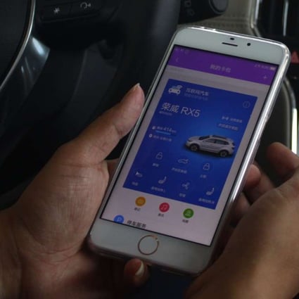 A driver demonstrates how to connect SAIC's Roewe RX5 SUV using Alibaba's YunOS operating system. The OS is on track to corner a 14 per cent share of smartphone shipments on the mainland by the end of this year. Photo: SCMP Pictures