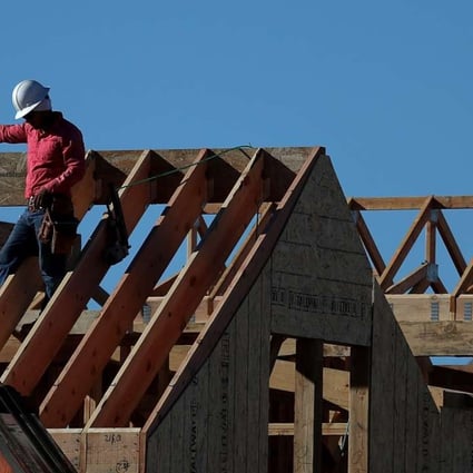 Workers in California work on a roof at a housing development in the state. Photo: AFP
