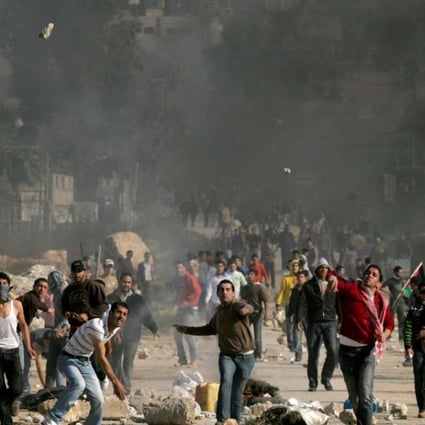 Young Palestinians throw stones at Israeli soldiers during clashes near the West Bank city of Tulkarem on January 9, 2009, in another instance of the mayhem of the last 70 years. Photo: AFP