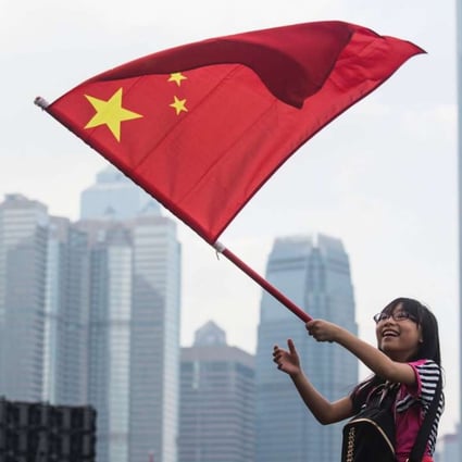 A young woman waves the national flag at a rally last month in support of the NPC’s interpretation of the Basic Law. Hong Kong people must fight the independence movement openly, with flags waving. Photo: AFP
