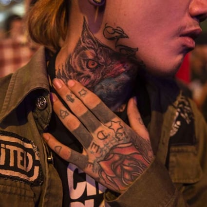 A tattooed headbanger at a heavy metal gig in Yangon, Myanmar. The heavy metal scene in the country has erupted out of the underground in recent years. Photos: AFP