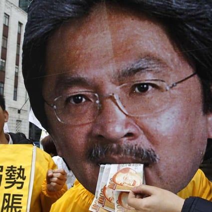 Protesters pillory Financial Secretary John Tsang in 2011 as they urge more support for the poor in his budget. Photo: AP