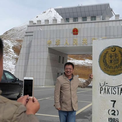 A photo-op for Chinese travellers at the Khunjerab Pass on the border with Pakistan, 4,600m above sea level, on September 29, 2015. Pakistan has received US$46 billion for the China-Pakistan Economic Corridor, which will link to the Pakistani ports of Gwadar and Karachi, giving Chinese exports access to the Arabian Sea. Photo: AFP