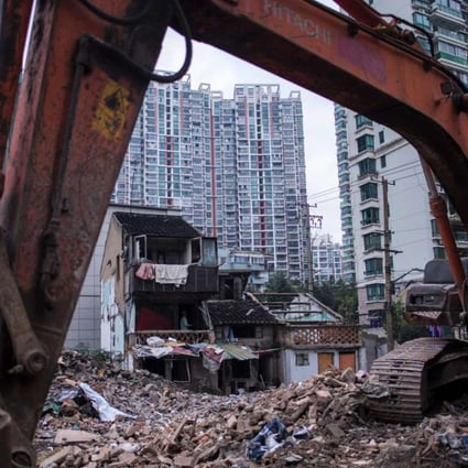 A man works at a site for residential buildings to make space for high-rise buildings in Shanghai. Photo: AFP