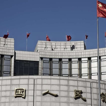 The Chinese national flag flies above the People's Bank of China head office in Beijing. Photo: Bloomberg