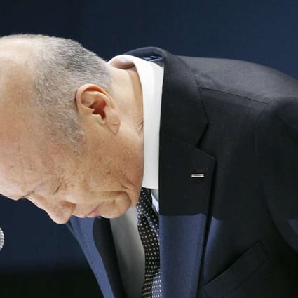 Tadashi Ishii, president of advertising giant Dentsu Inc., bows in apology at a press conference in Tokyo. Ishii said he will step down in January 2017 to take responsibility for the overwork-related suicide of a 24-year-old female employee. Photo: Kyodo