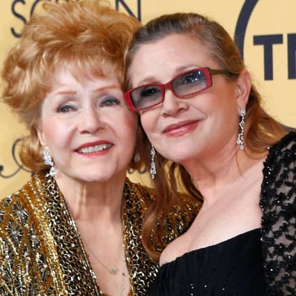 Debbie Reynolds poses with her daughter Carrie Fisher backstage after accepting her Lifetime Achievement award at the Screen Actors Guild Awards in Los Angeles in 2015. Photo: Reuters