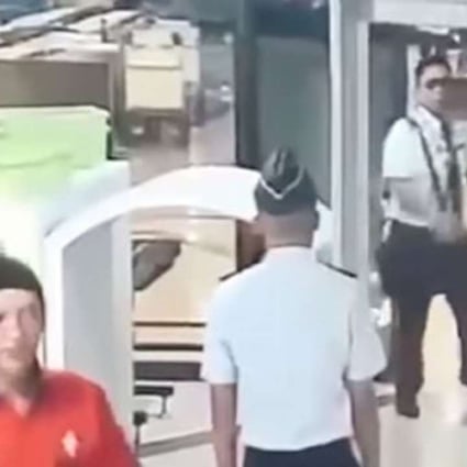 YouTube footage showed 32-year-old pilot Tekad Purna staggering through a metal detector at airport security and dropping his bag and belongings several times after arriving late for his flight.