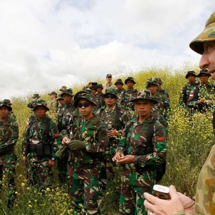 An Australian soldier briefs Indonesian personnel during joint drills. Photo: Reuters