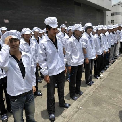 Foxconn workers line up outside a factory building in Shenzhen in May 2010. Photo: AFP