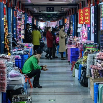 A vendor at the Yiwu wholesale market in Zhejiang province. Rising global protectionism and sluggish demand from consumers are already hurting China’s exports. Photo: AFP