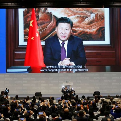 President Xi Jinping addresses the audience via video link during the opening ceremony of the third annual World Internet Conference in Wuzhen, Zhejiang province, last November 16. His presence at Davos is set to mark a consecration for China. Photo: Reuters