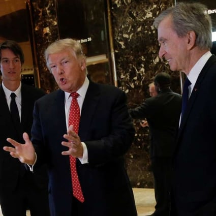 US President-elect Donald Trump speaks to reporters, with LVMH’s Bernard Arnault (right) and his son Alexandre Arnault (left), at Trump Tower in New York last week. Photo: Reuters