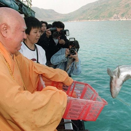 Reverend Sik Wing-sing releases a fish off Sai Kung in a “saving life” ritual in 1997. The practice is widespread in the city. Picture: Robert Ng