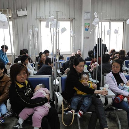 Chinese families accompany their children to get flu to rabies shots at a hospital in Hefei. Photo: AFP
