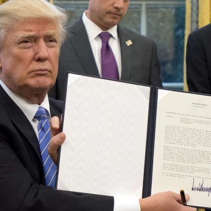 US President Donald Trump shows the Executive Order withdrawing the US from the Trans-Pacific Partnership (TPP). Photo: EPA