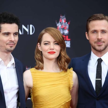 Emma Stone and Ryan Gosling, stars of La La Land, pose with its director Damien Chazelle. The musical secured a record-equalling 14 Oscar nominations. Photo: EPA