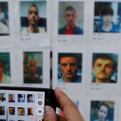 A journalist takes a photo of some of the suspects in the case. Photo: Reuters.