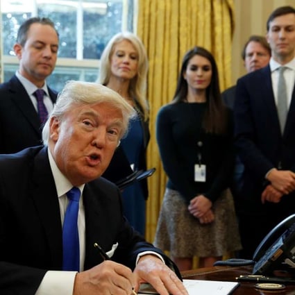 President Donald Trump shows his signature on an executive order on the Keystone XL pipeline, Tuesday, Jan. 24, 2017. Photo: Reuters