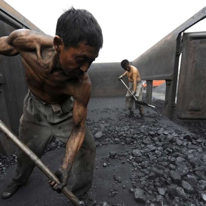 Workers unload coal at a storage site along a railway station in Hefei, Anhui province, China. Photo: Reuters