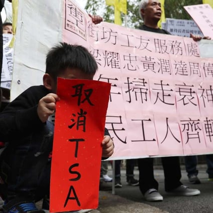A young boy holds up a “fai chun” saying “cancel TSA”, at a protest against Chief Executive Leung Chun-ying’s performance, outside Government House on January 30. Photo: Nora Tam