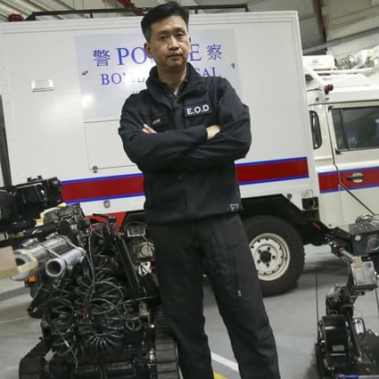 Senior bomb disposal officer Tony Chow poses with some robotic equipment. Photo: David Wong