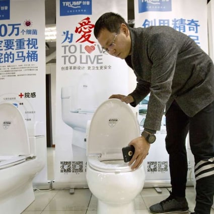 Zhong Jiye, a co-founder of Shenzhen Trump Industrial Co pictured with one of the firm’s Trump-branded toilets. Photo: AP