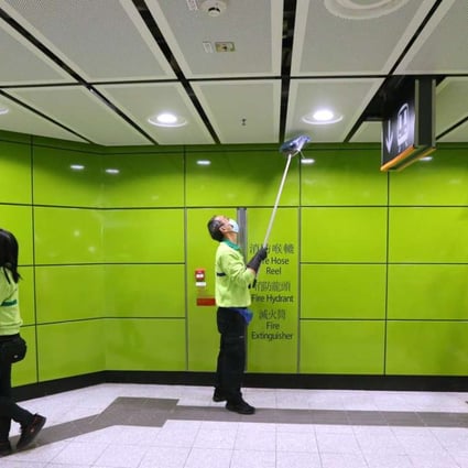 MTR staff cleaning inside the South Horizons MTR station. Photo: Dickson Lee