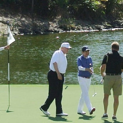 US President Donald Trump, second from left, and Japan's Prime Minister Shinzo Abe, centre, play a round of golf in Florida. Photo: AFP