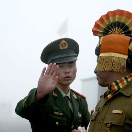 A Chinese soldier and an Indian counterpart on the Chinese side of the ancient Nathu La border crossing between India and China. Photo: AFP
