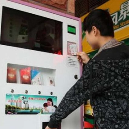 A man buys a pack of condoms from a vending machine in China. Photo: Handout