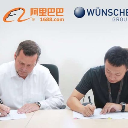 Andre Zuppa (left), managing director of Wünsche Food, signs an agreement with Alibaba