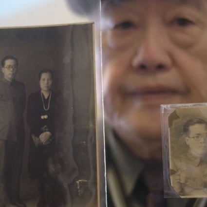 Pan Hsin-hsing displays pictures of his parents during an interview in Taipei. He was just six when his father, Pan Mu-chih, a doctor and local politician, was arrested, tortured and killed in the “228 Incident” that was followed by the “White Terror” purges. Photo: AFP