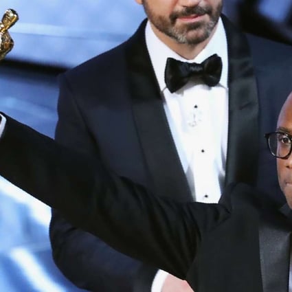Moonlight director Barry Jenkins holds up the best picture Oscar on Sunday. Photo: Reuters