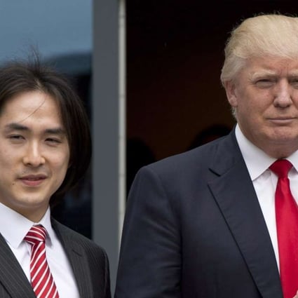 In this 2013 file photo, Donald Trump gives a thumbs-up as he poses with Tiah Joo Kim, left, CEO and president of Holborn Group, upon arrival to announce the building of Trump International Hotel and Tower Vancouver in downtown Vancouver, Canada. Photo: The Canadian Press via AP